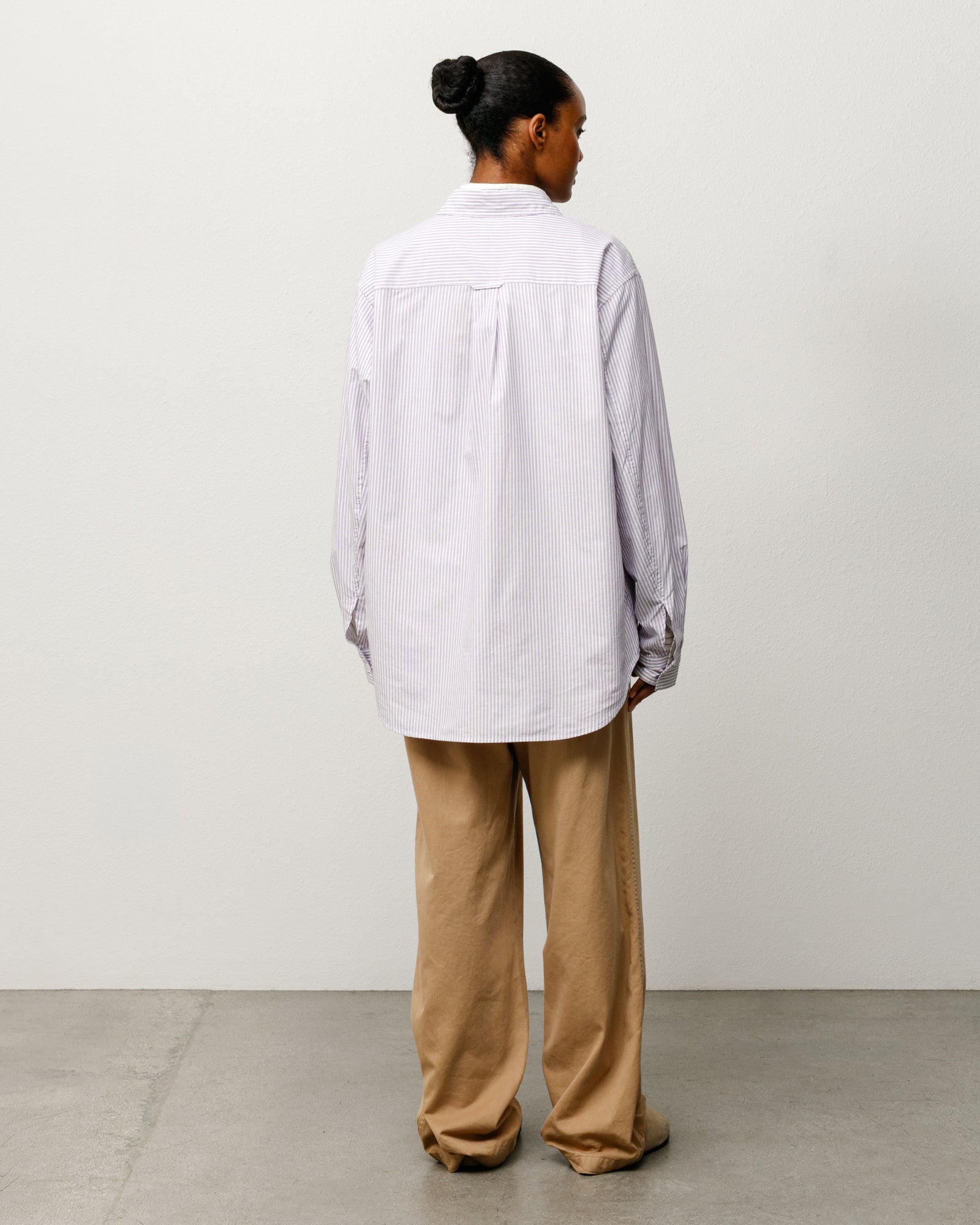 Purple striped unisex long sleeve shirt, relaxed fit, back view on model