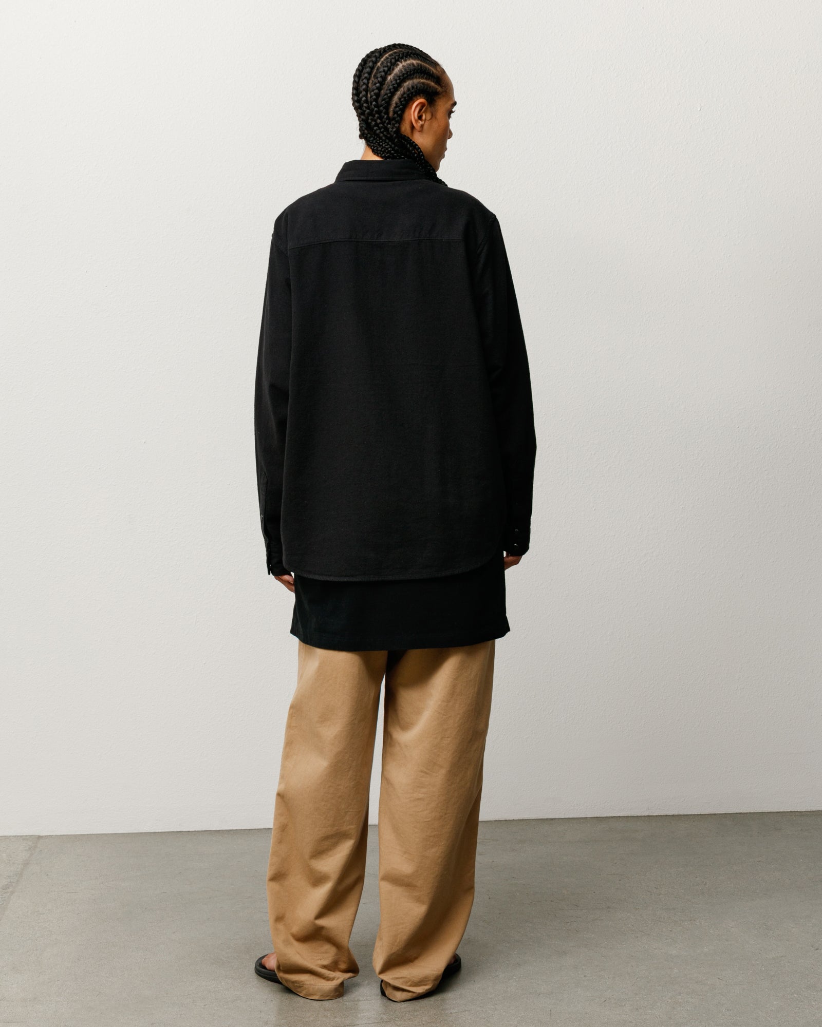 Unisex black cotton‑silk western shirt with long sleeves, back view on model.