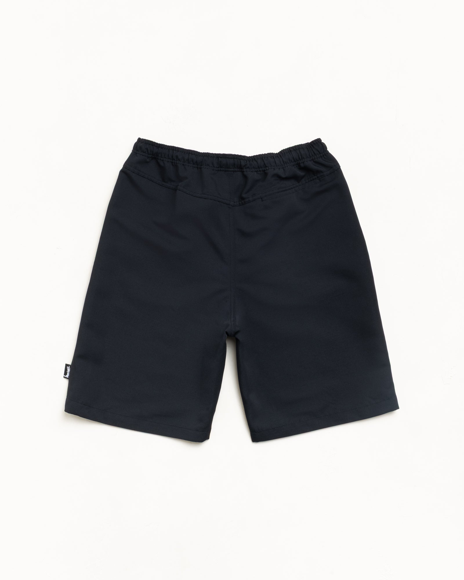 Black Baggy Beach Short, back view with elasticated waist and Stüssy side flag label