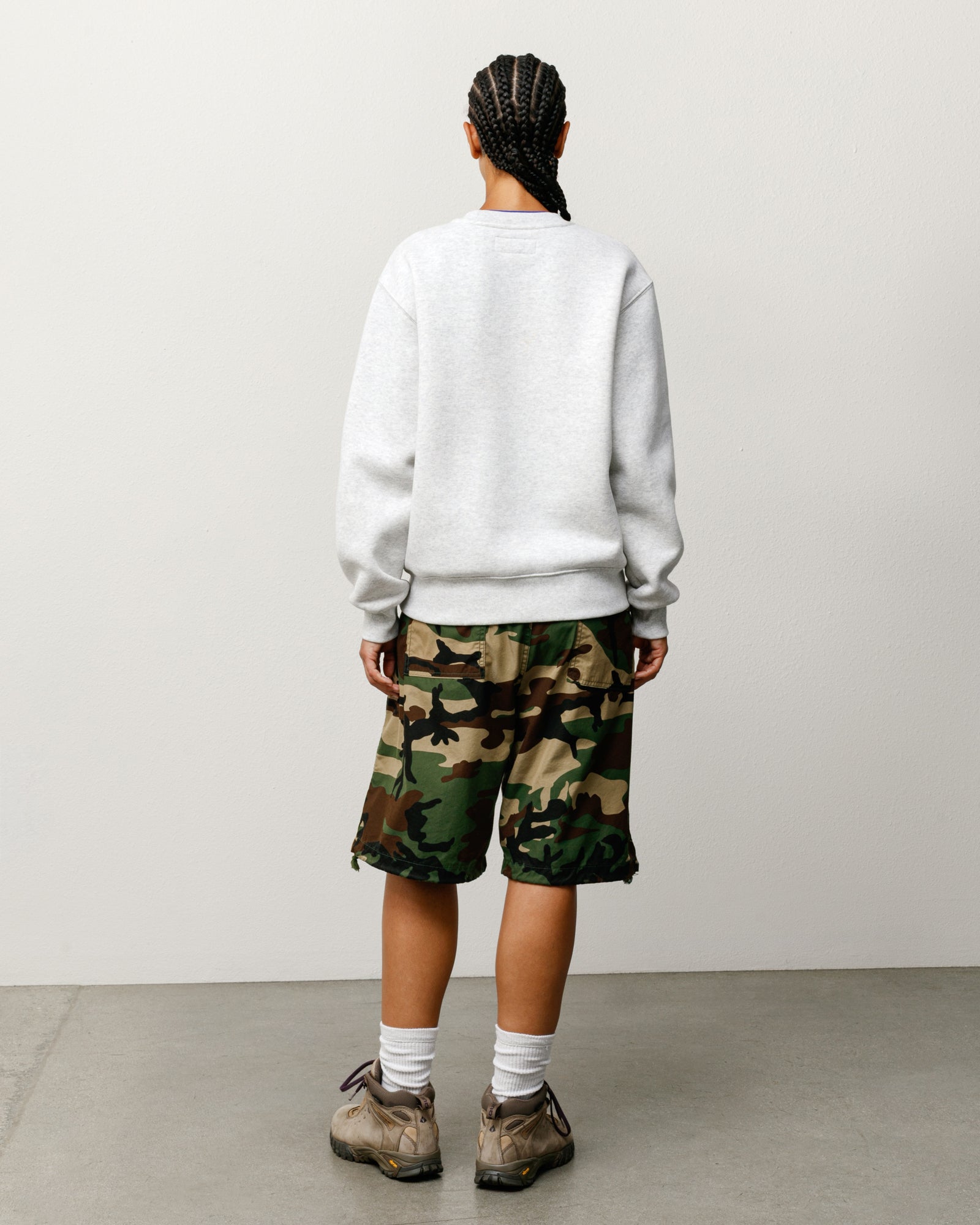 Woodland camo shorts, back view on model with rear flap pockets and drawcord hems