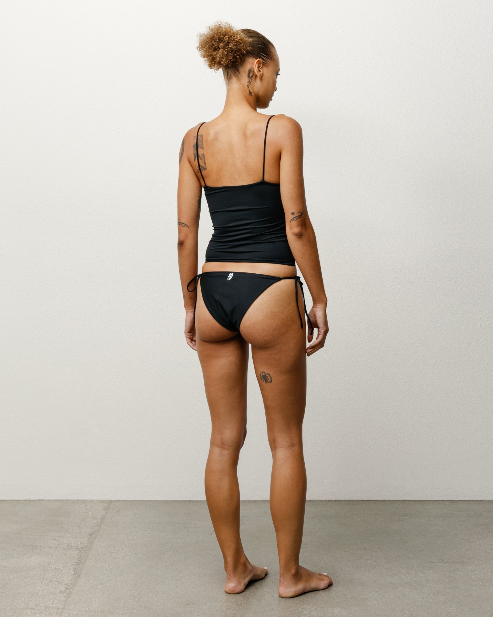 Side Tie Bikini Bottom Womens in the colour Black featuring side ties, seen from the back