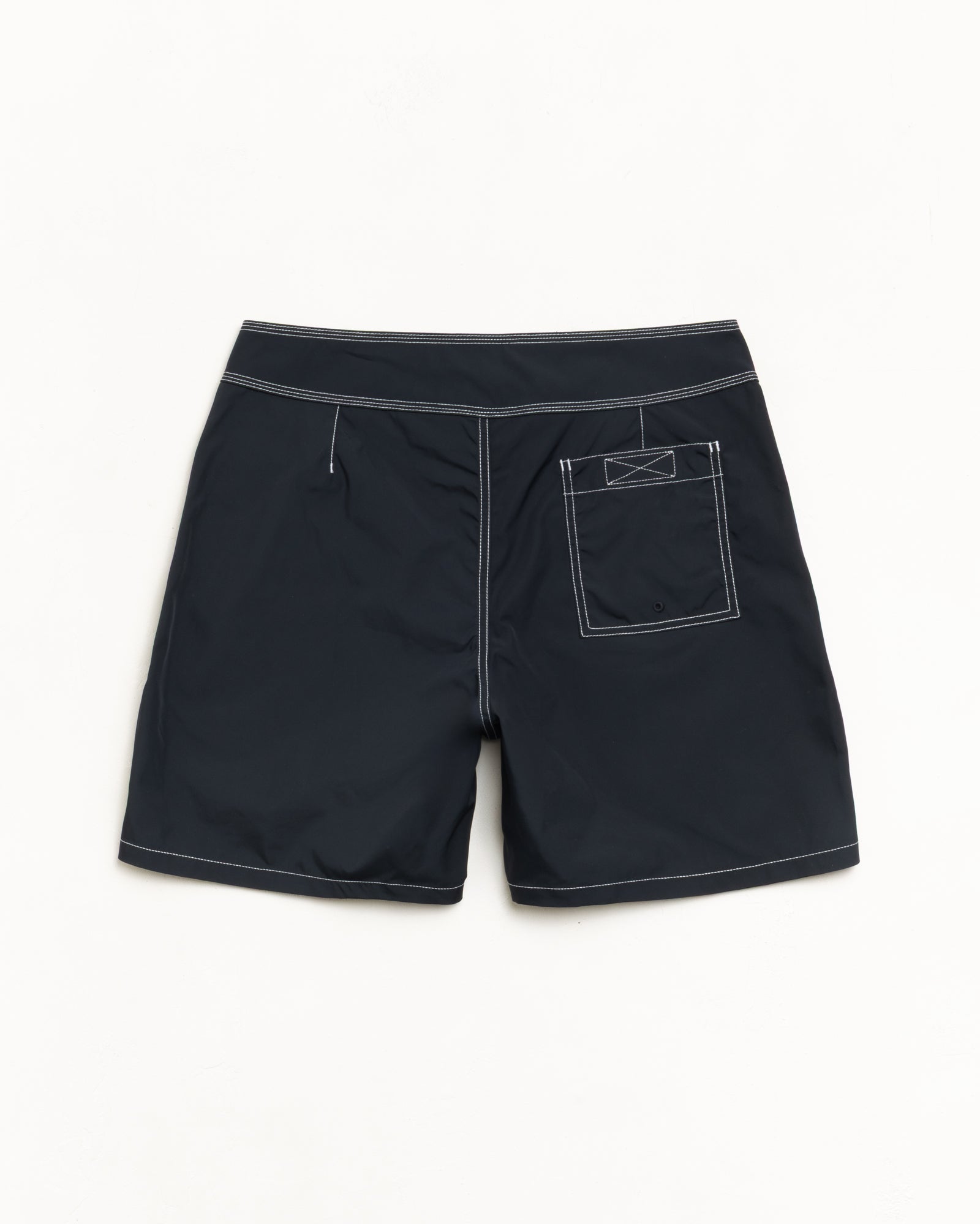 Coastal board short in black, back view with contrast stitching and rear patch pocket
