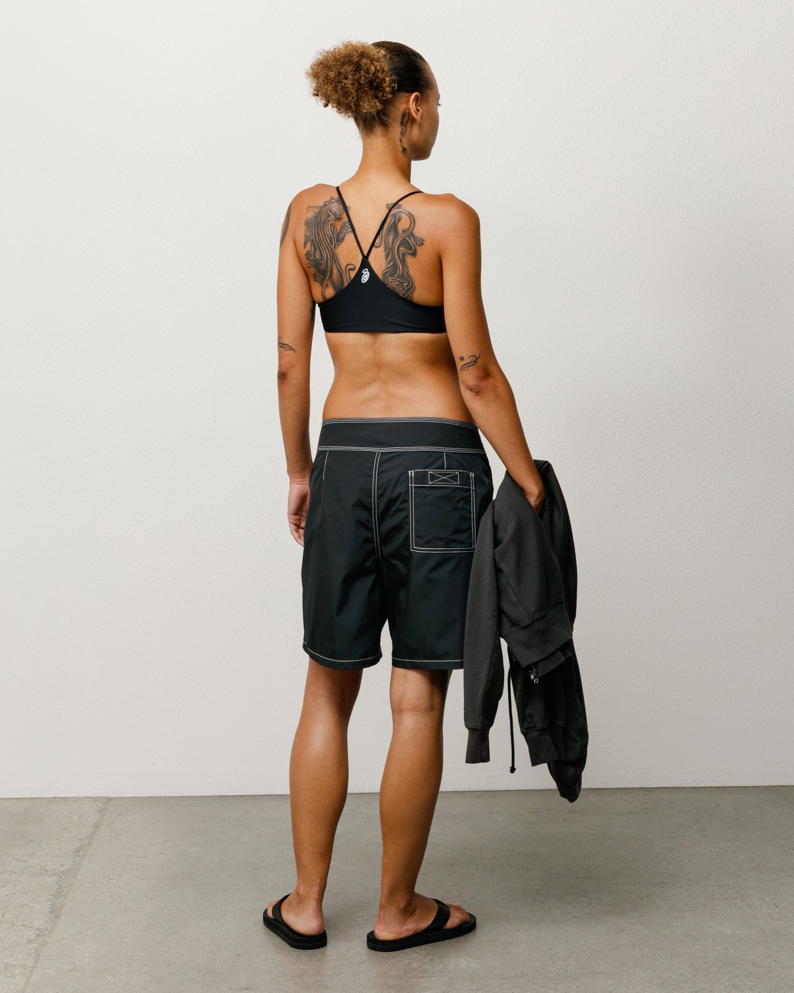 Coastal Board Short Unisex In Black, Back View With White Contrast Stitching And Rear Patch Pocket