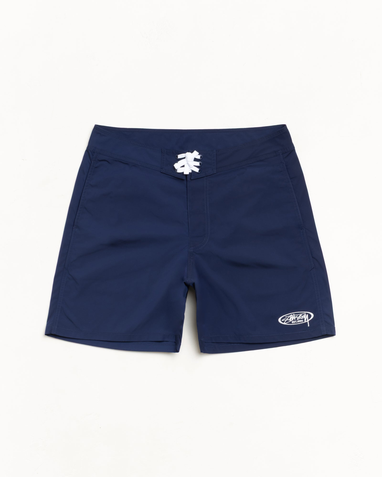 Blue board shorts with white lace-up waistband and logo embroidery at left hem