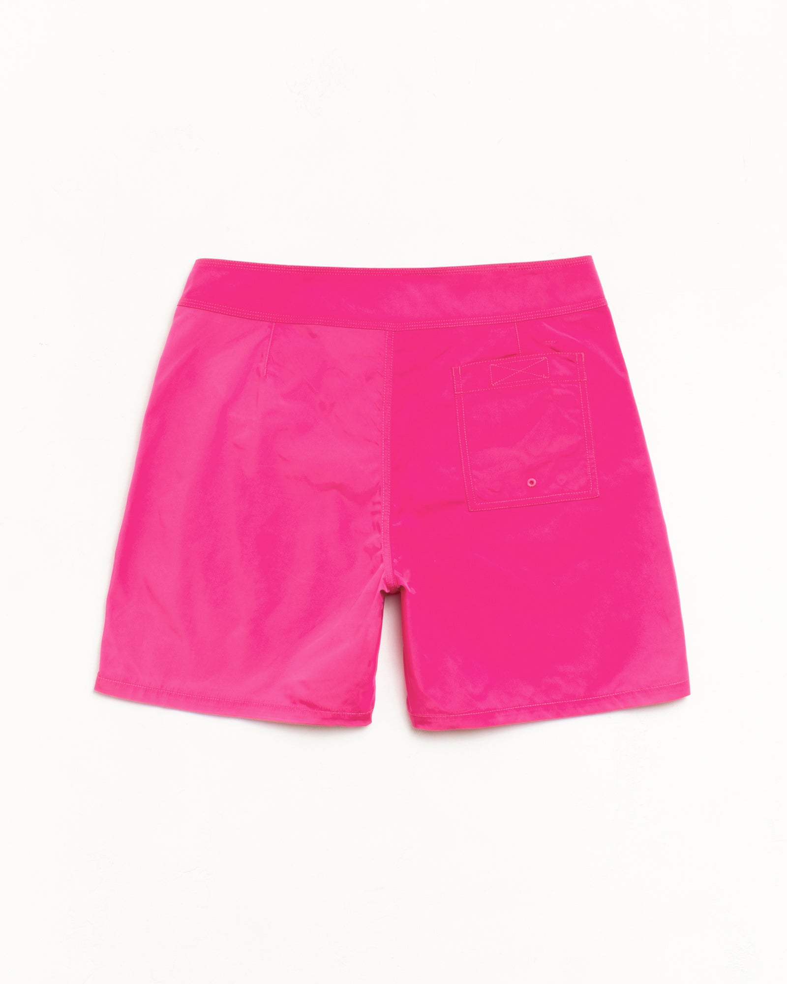 Bright pink board shorts, back view, lightweight fabric with rear patch pocket and drainage eyelet