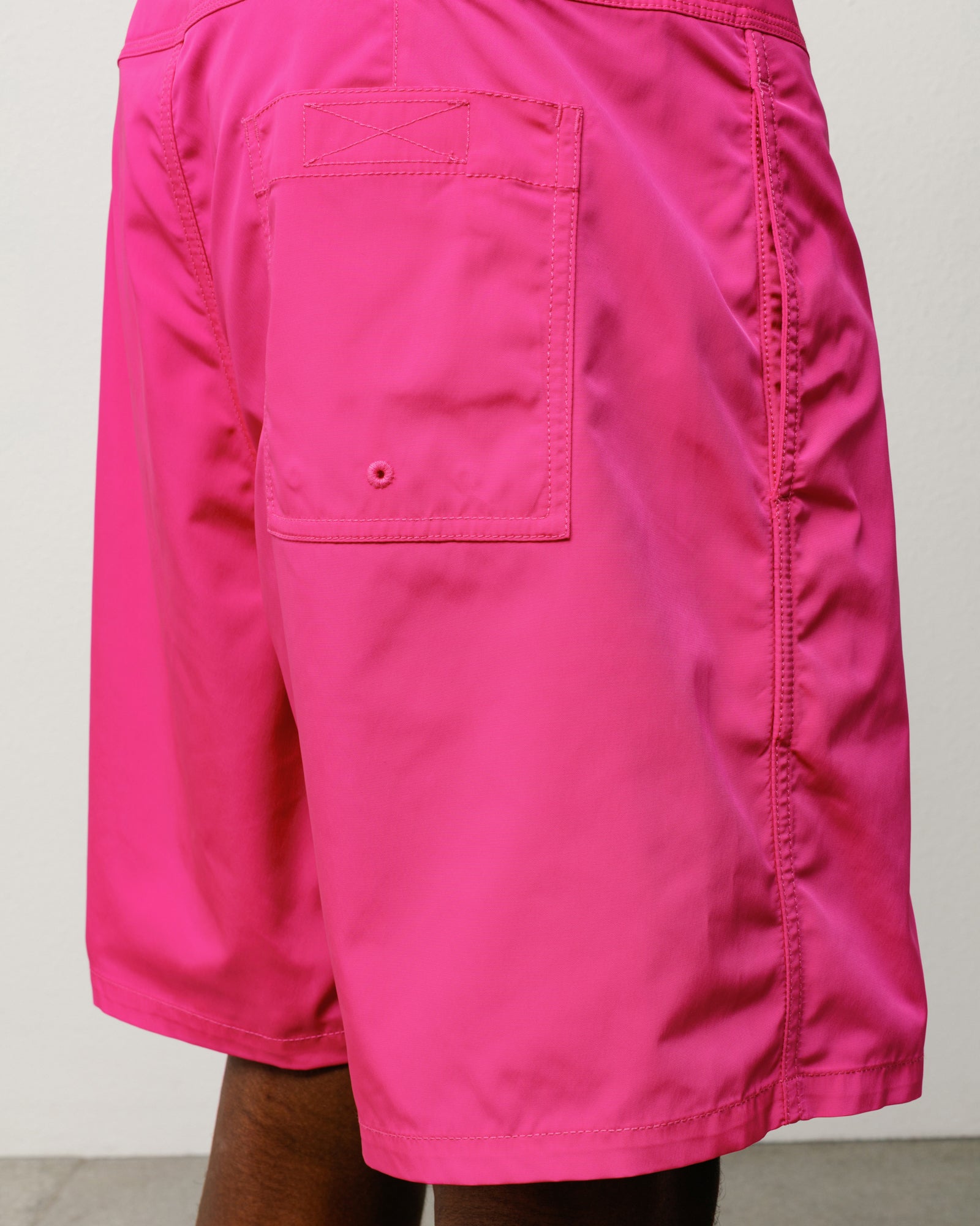 Pink board shorts, back view with rear patch pocket and drainage eyelet
