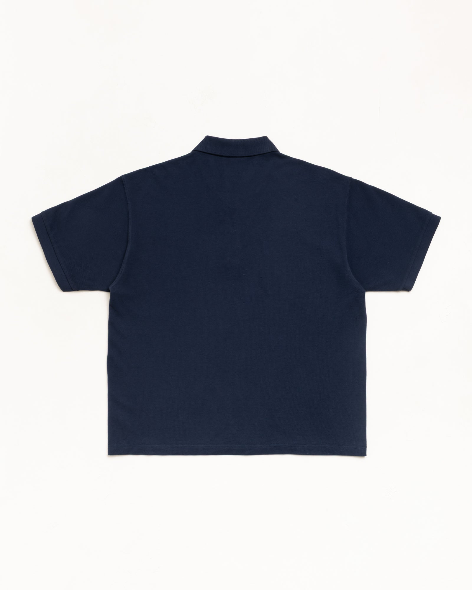 Navy cotton pique polo shirt, back view flat lay with short sleeves