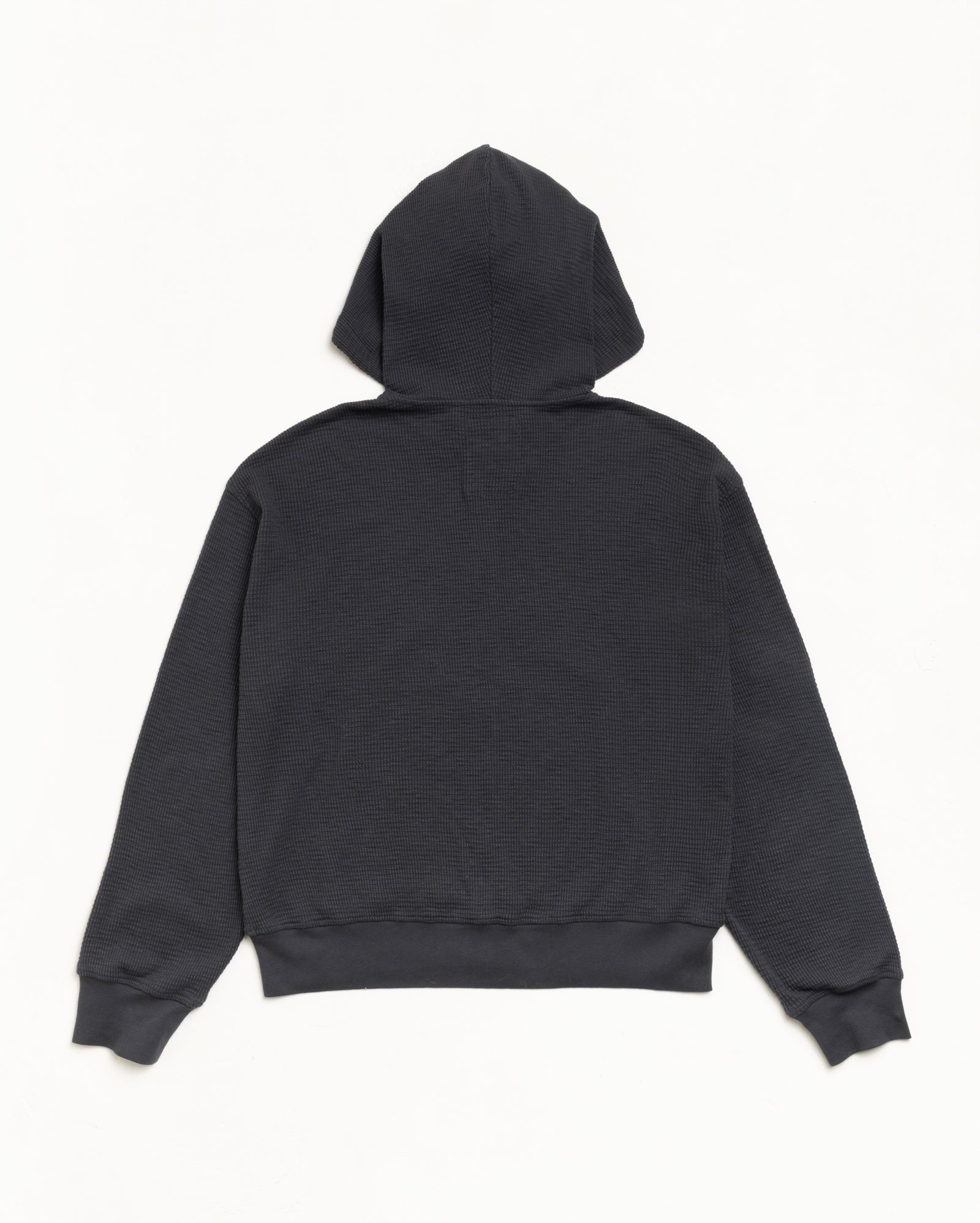 Faded black lightweight thermal hoodie in waffle-knit cotton, back view