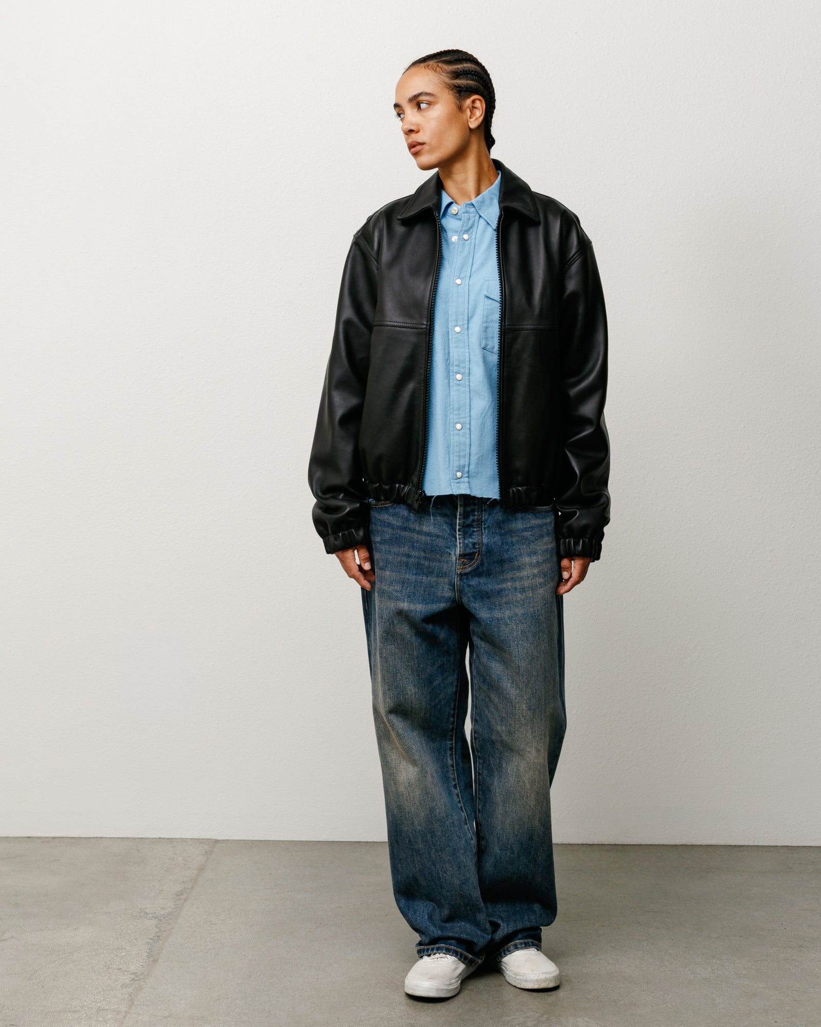 Blue baggy denim jeans on model, relaxed fit with faded wash and wide legs