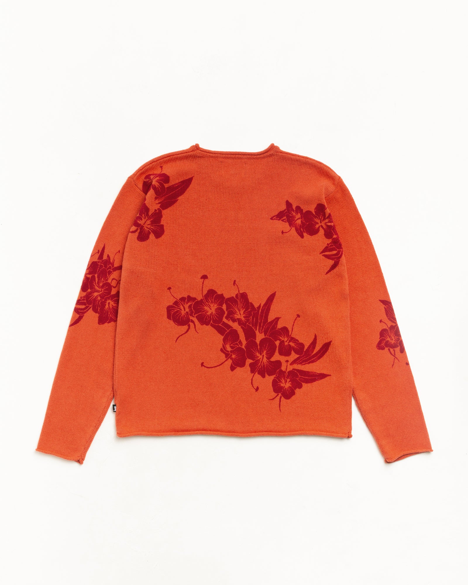Rust floral roll neck sweater, back flat lay with red jacquard knit and rolled edges.