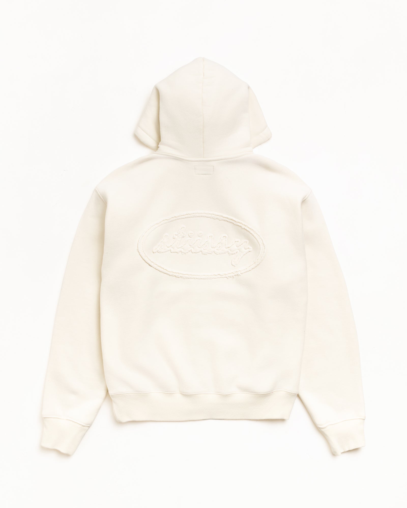 Natural zip hoodie, back view with tonal cursive applique logo and ribbed hem