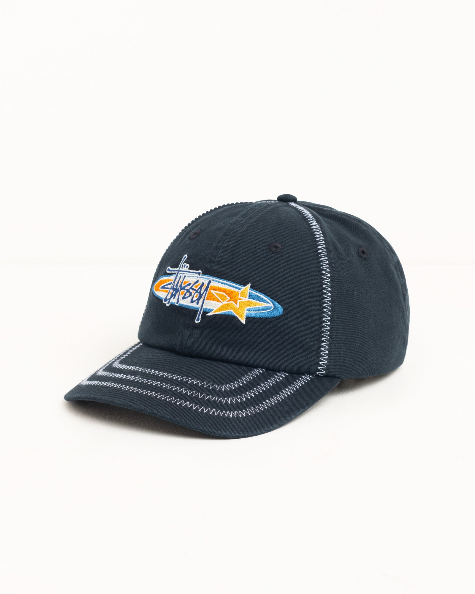 Black cotton twill cap with contrast zigzag stitching and Stüssy logo embroidery