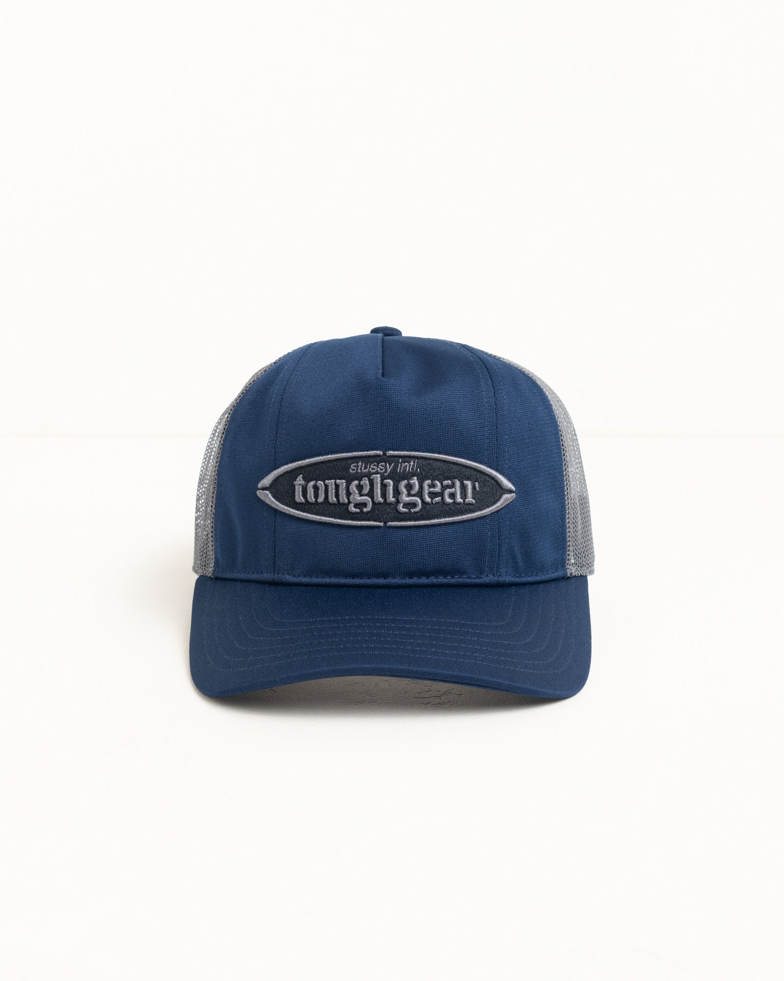 Mid-depth unisex trucker cap in navy with grey mesh sides and raised logo embroidery