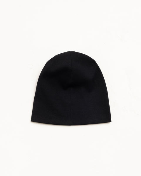 Black cotton jersey skullcap beanie, flat lay on white background