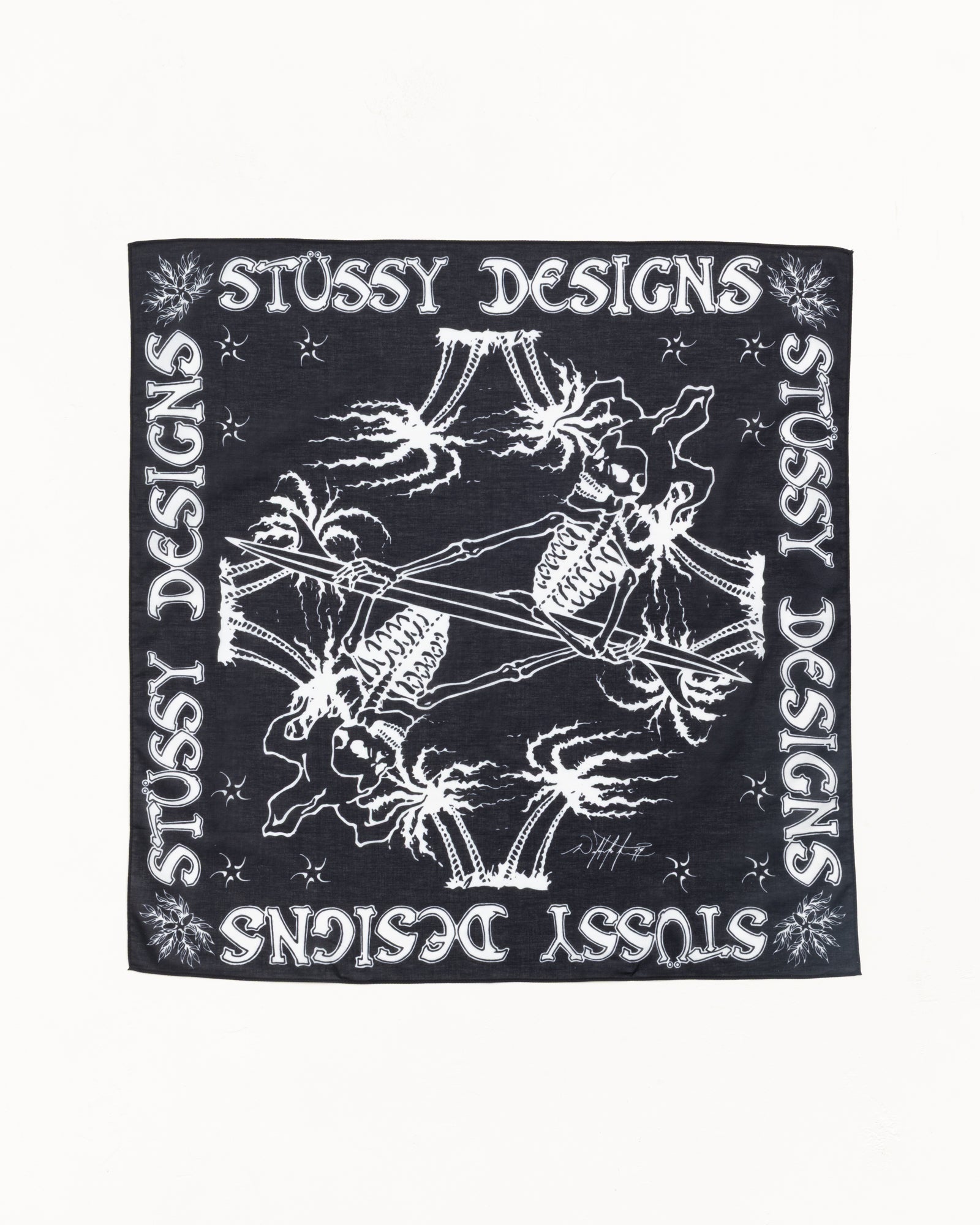 Black cotton bandana with white Stussy Designs border and mirrored skeleton surfer print