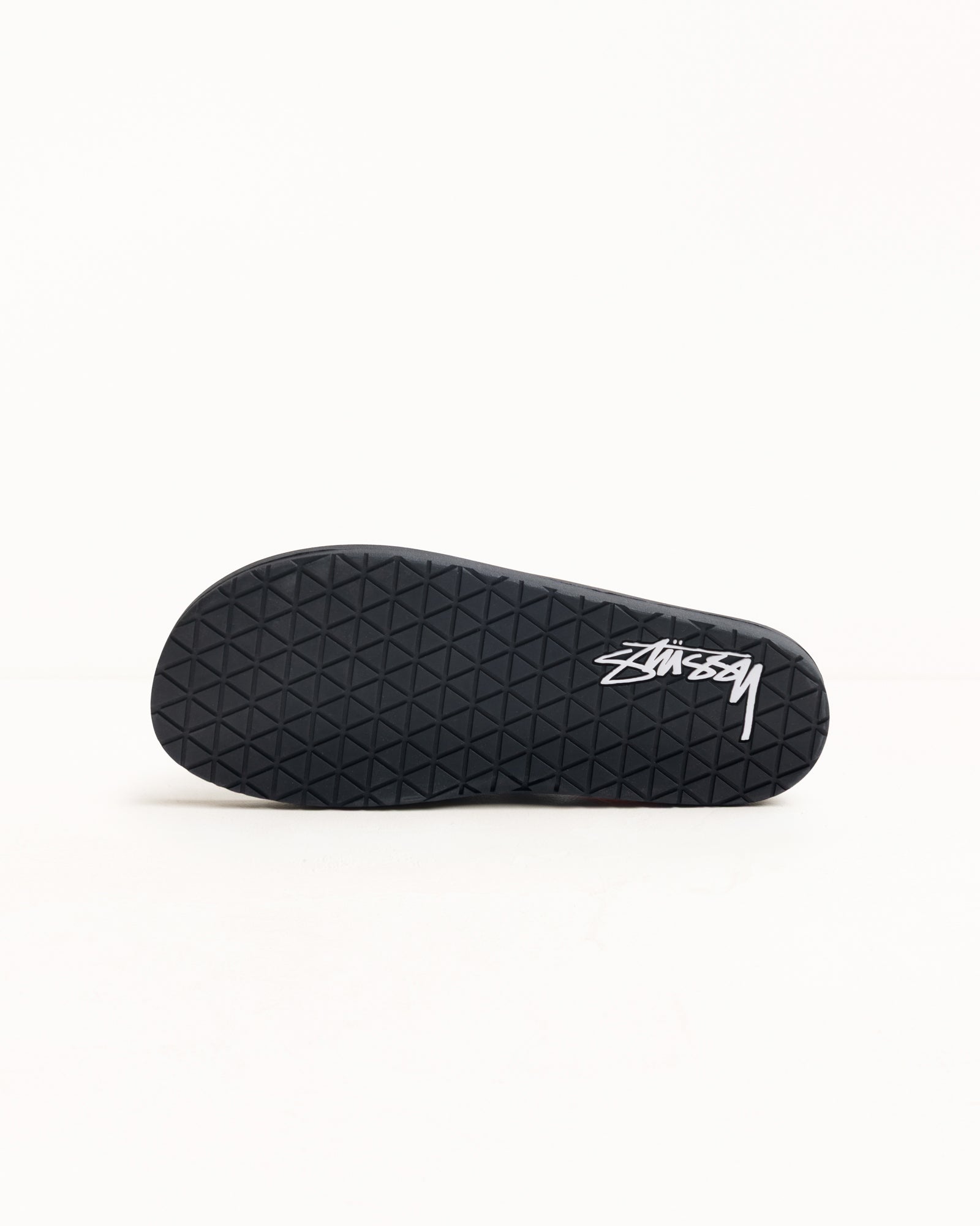 Rubber Flip-Flop In Black Outsole View With Diamond Tread And White Logo